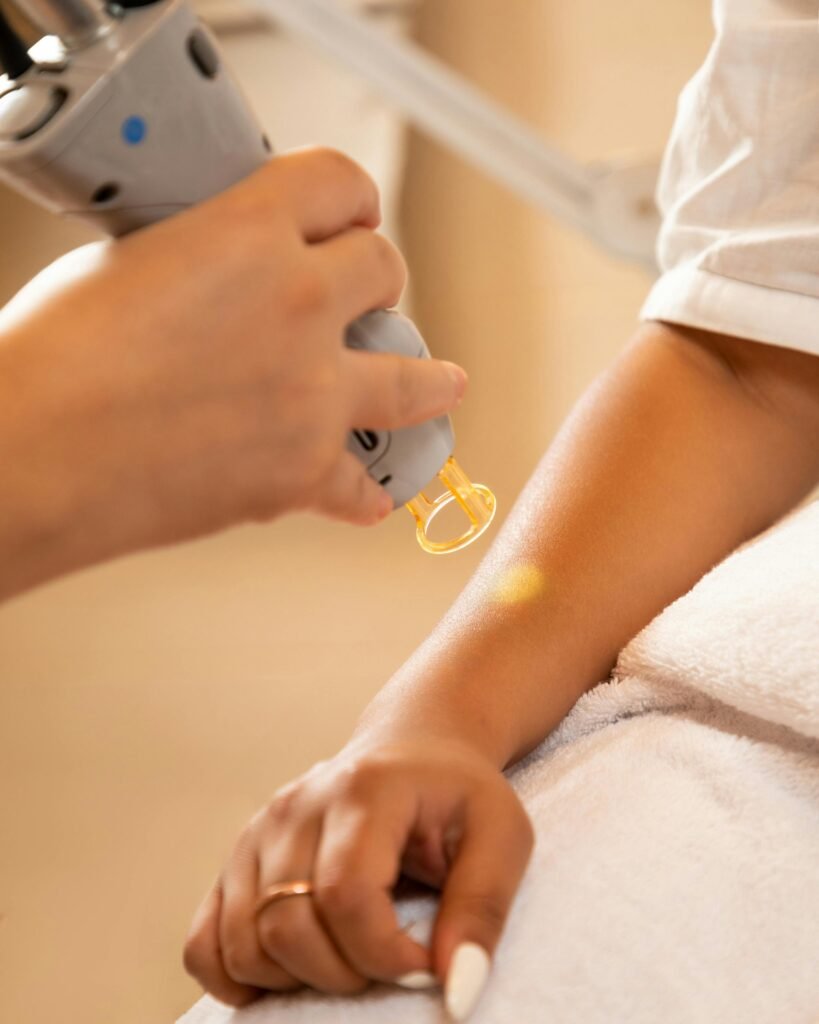 pexels-photo-19239092-19239092 Laser hair removal in the beauty salon. Woman having professional laser epilation procedure of arm